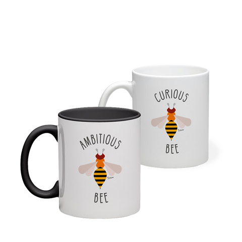 Duo of mugs, one black and white and the other all white. Both are decorate with a Totem of a bee. 